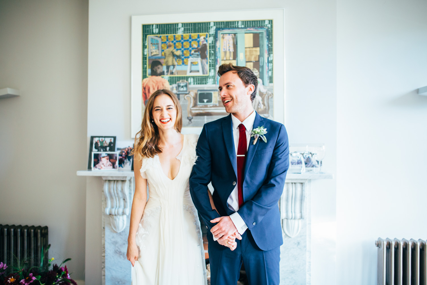 laughing bride and groom at home wedding photography in suffolk