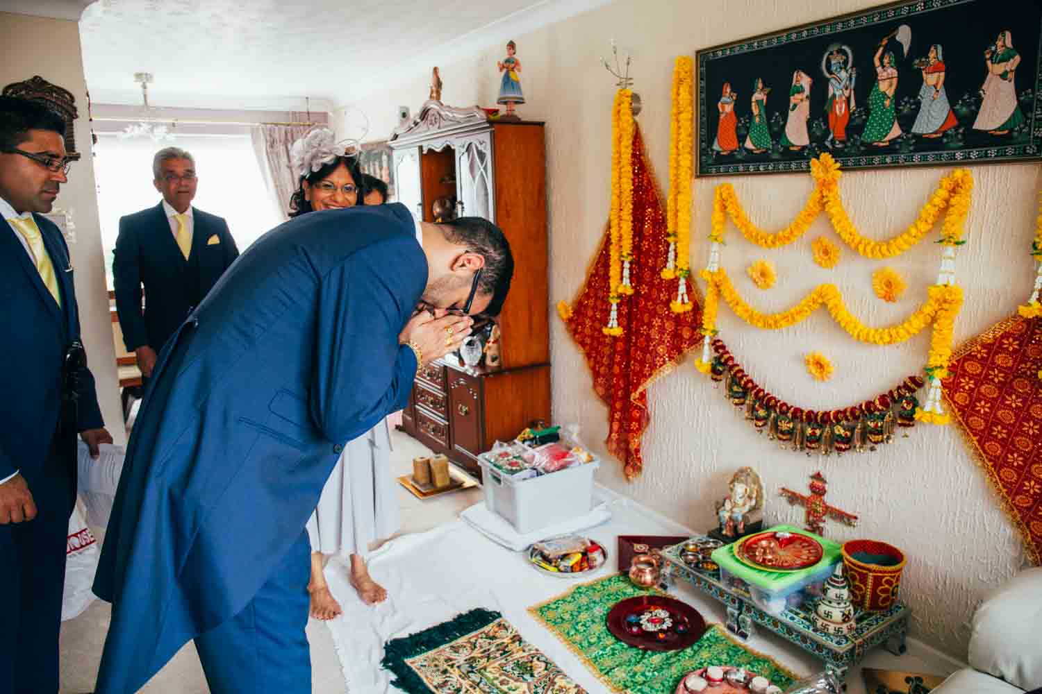 groom praying before indian wedding celebration at the boathouse in norfolk