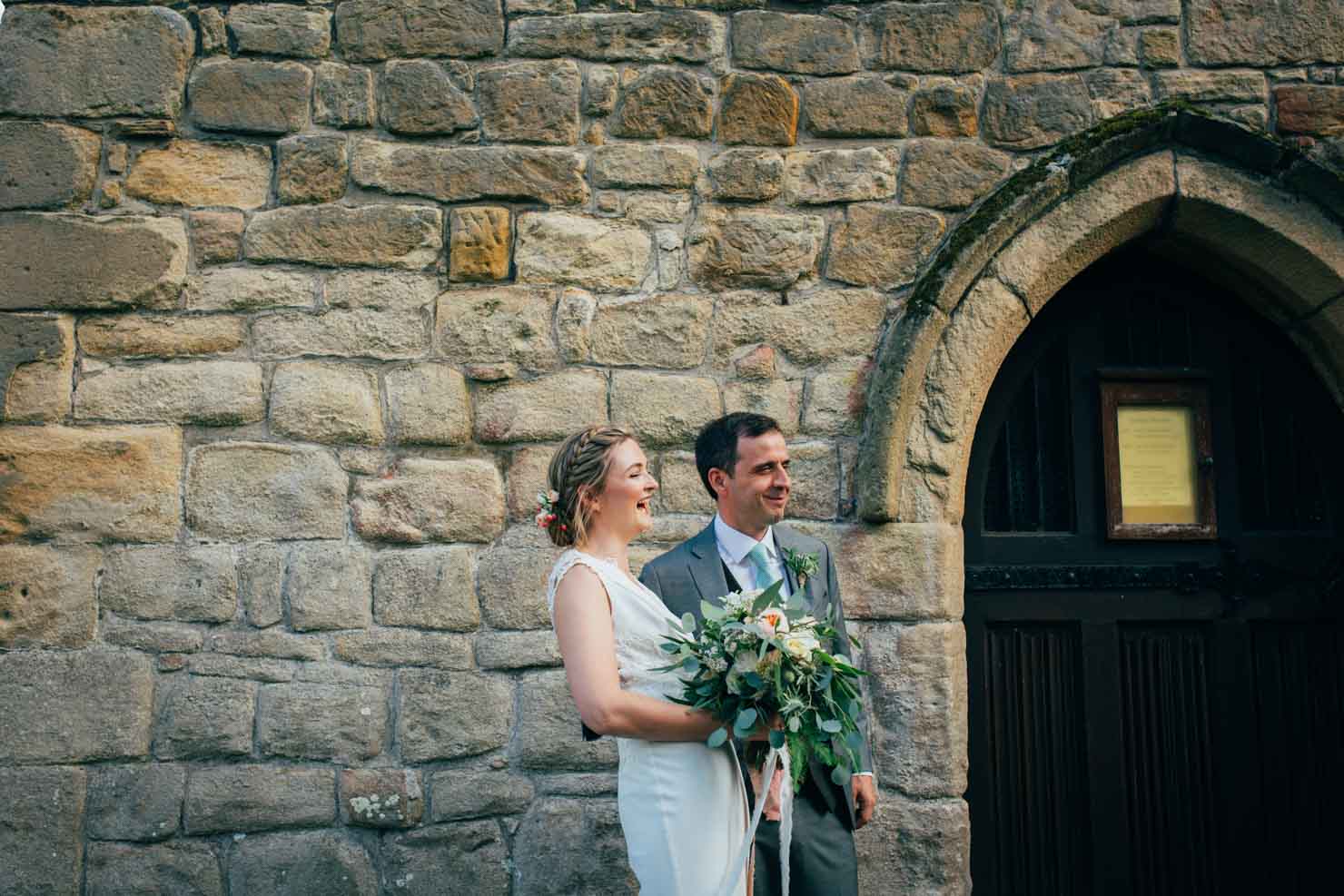 newlywed relaxed bride and groom laughing together in suffolk