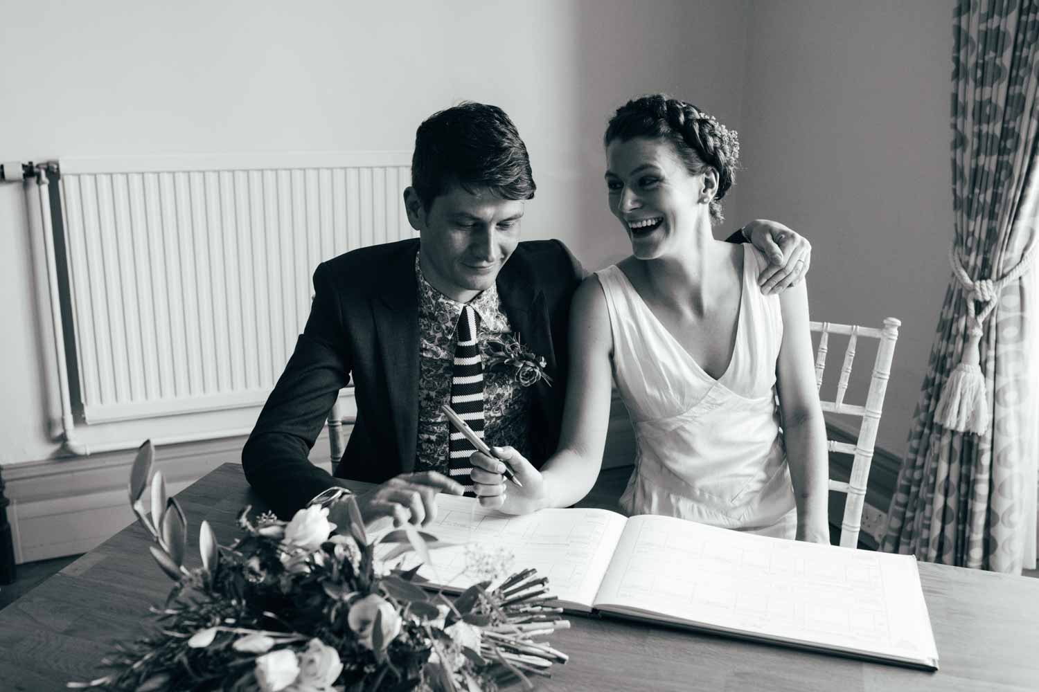newlyweds signing the register at norwich castle Wedding Photographer