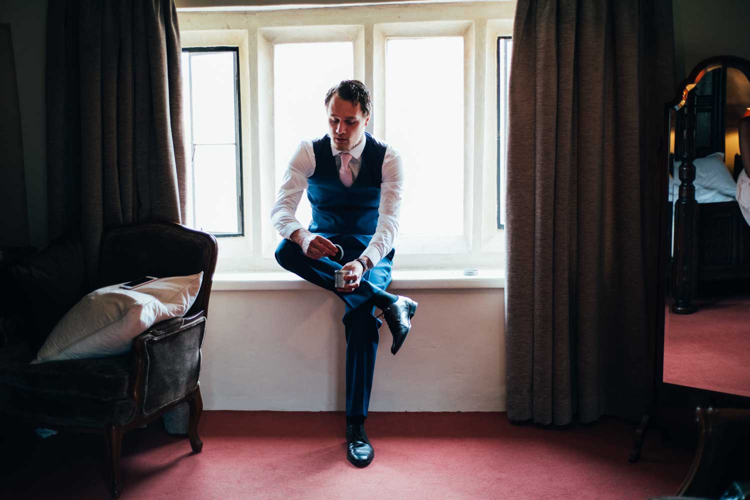 groom getting ready at oxnead hall in norfolk