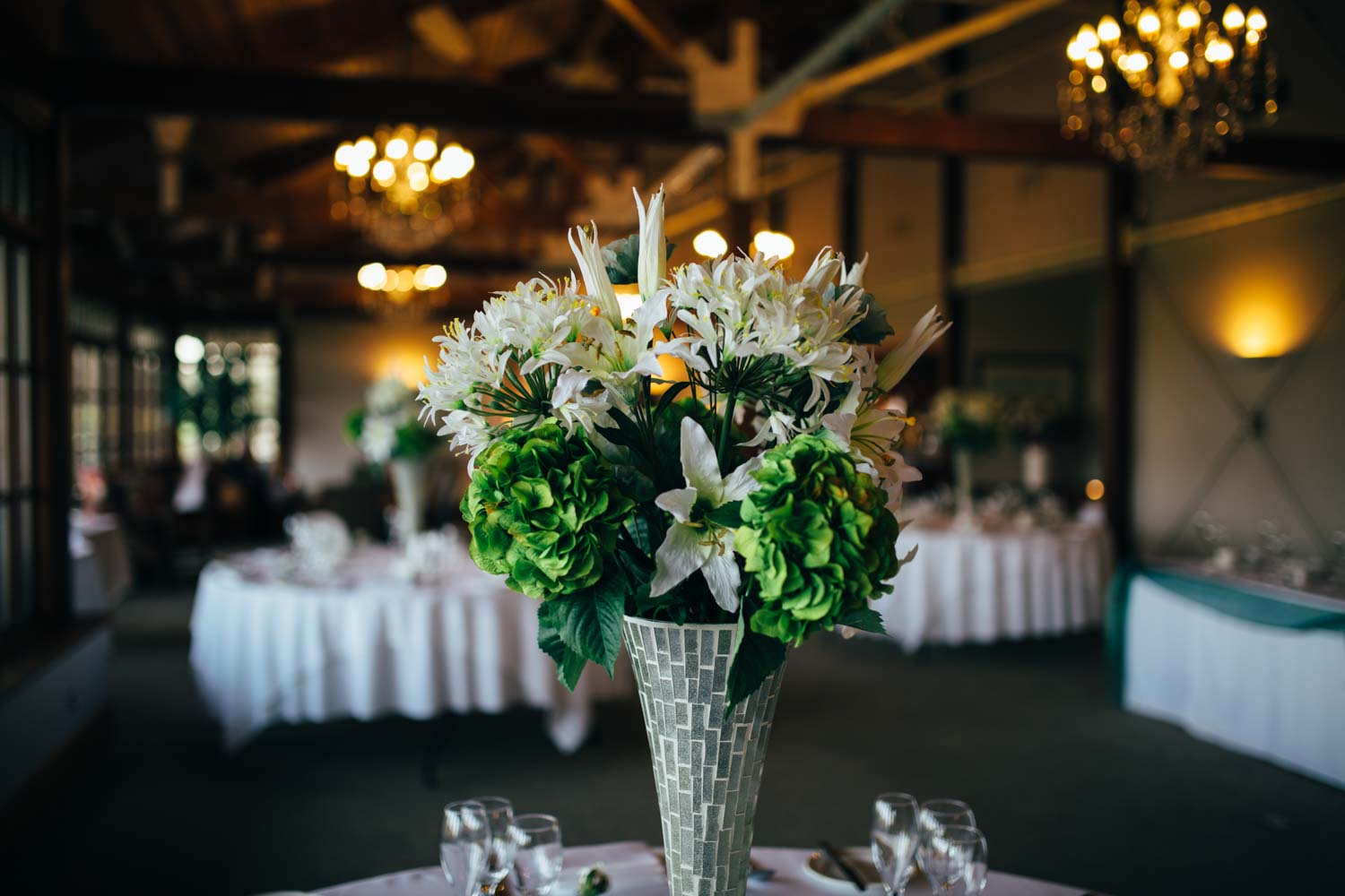 photography of green wedding centrepieces at hintlesham golf club reception
