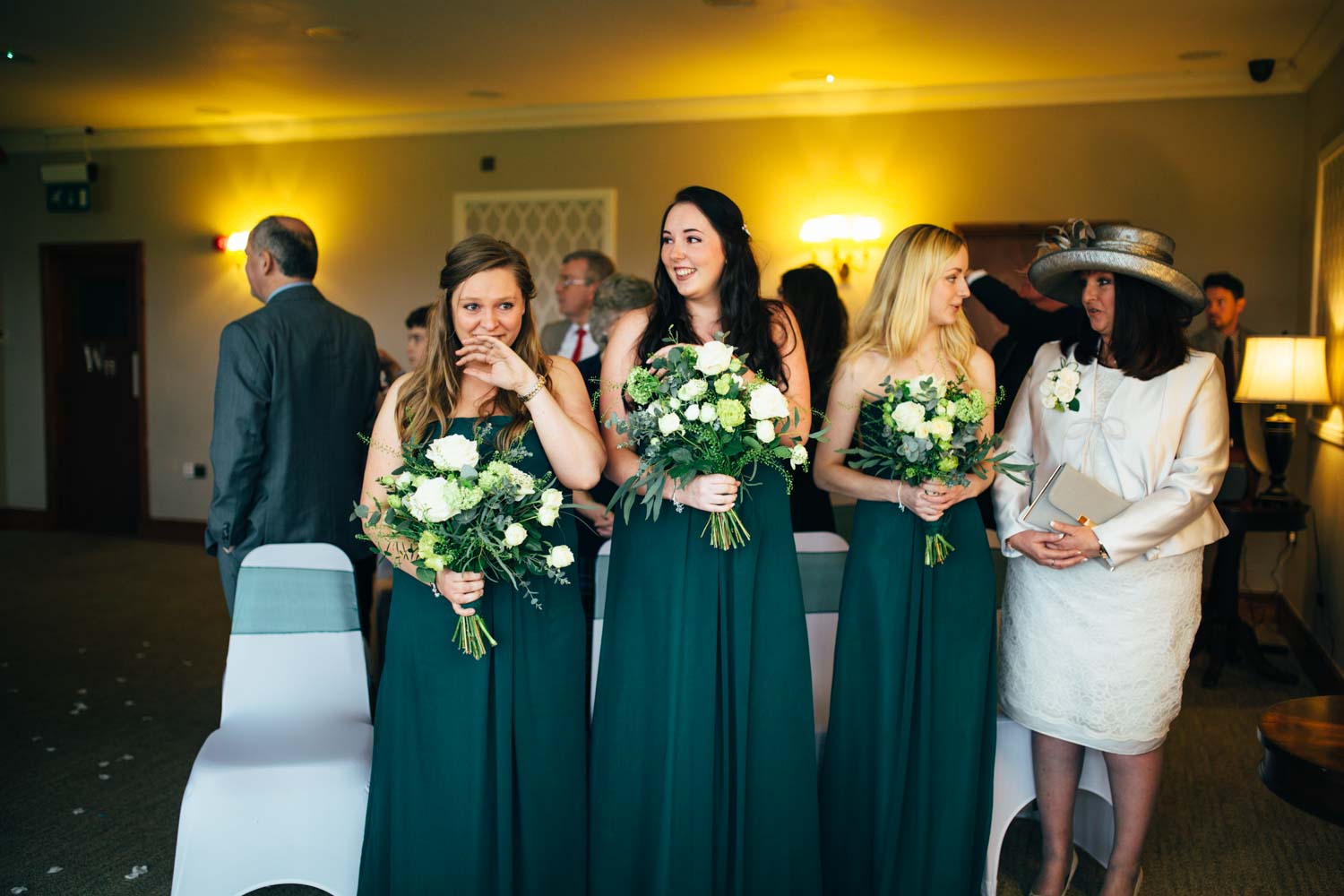 green bridesmaids at hintlesham hall wedding ceremony by a suffolk photographer