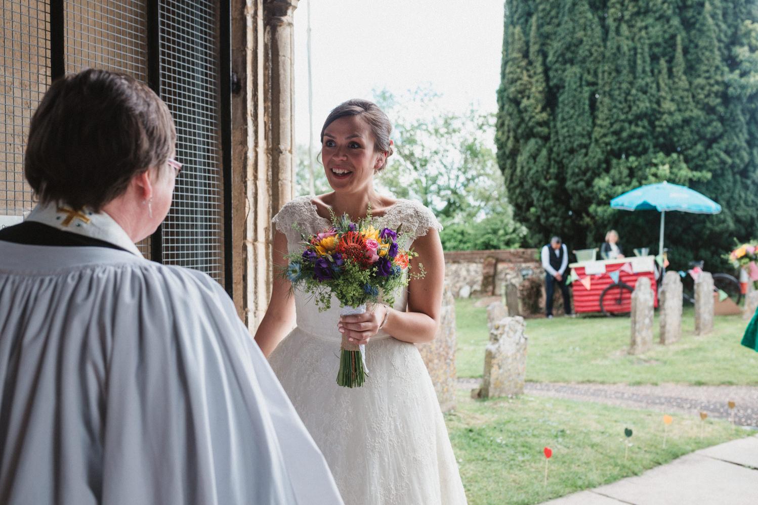 Norfolk bride greets vicar before wedding ceremony