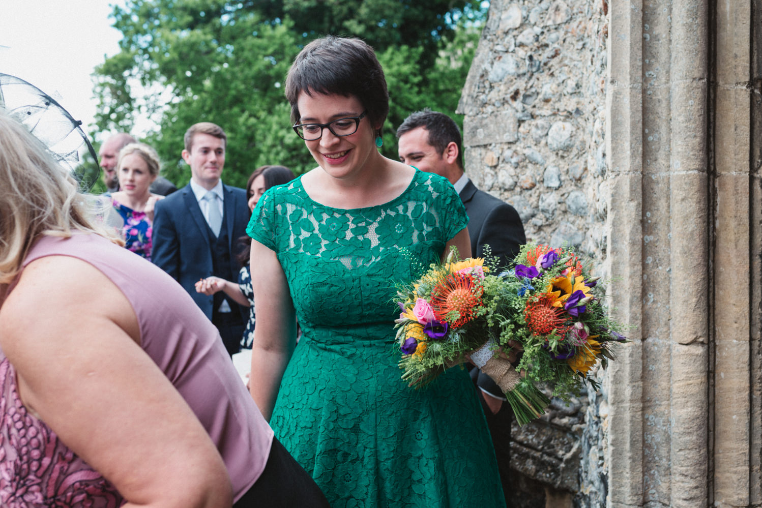 Bridesmaid in green dress after norfolk church wedding ceremony