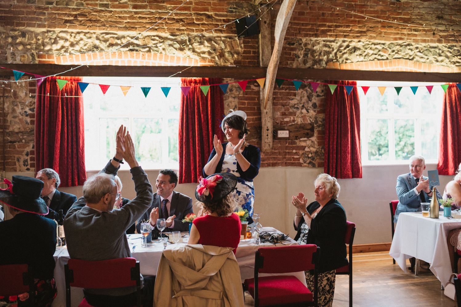Guests at Norfolk suffolk relaxed tithe barn wedding guests clapping