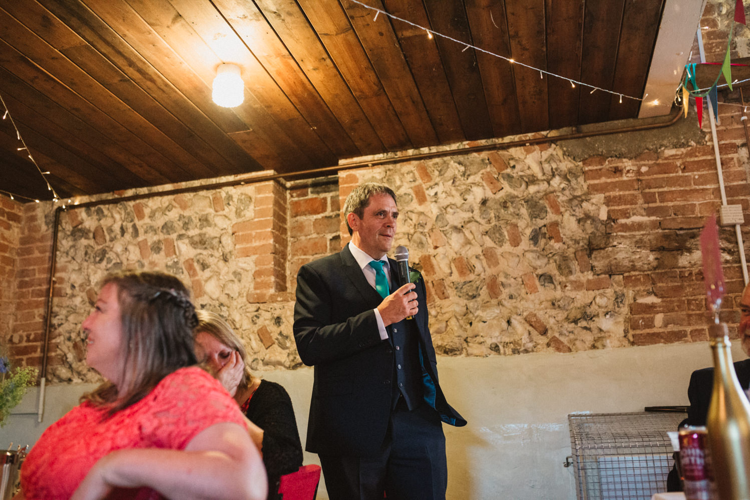 Guests at Norfolk suffolk relaxed tithe barn wedding speeches