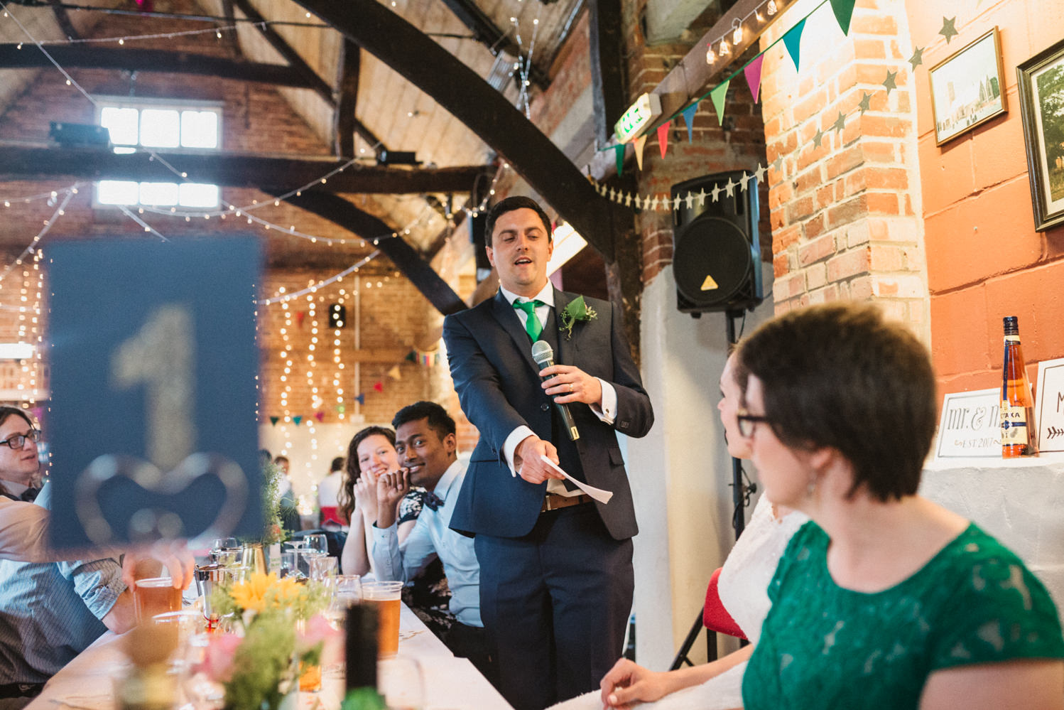 Guests at Norfolk suffolk relaxed tithe barn wedding speeches
