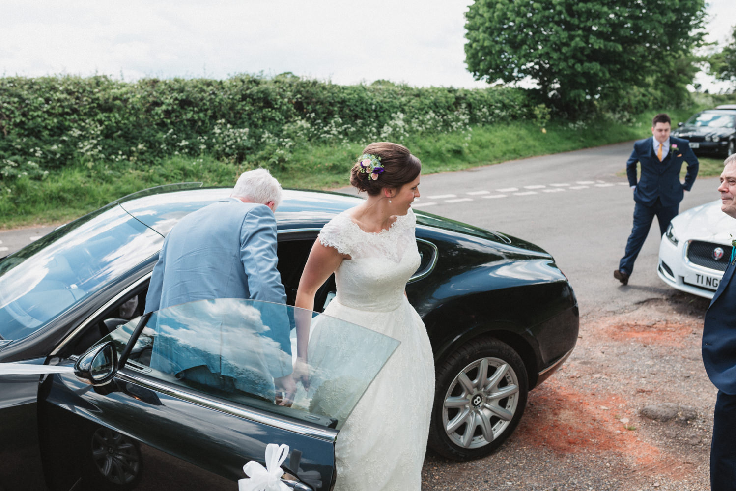 Relaxed norfolk bride arrives at the ceremony