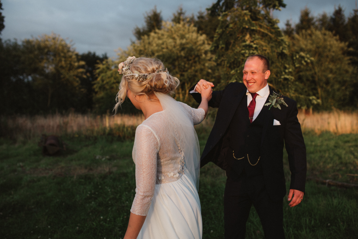 relaxed bride and groom dancing at sunset wedding in woodbridge, suffolk 