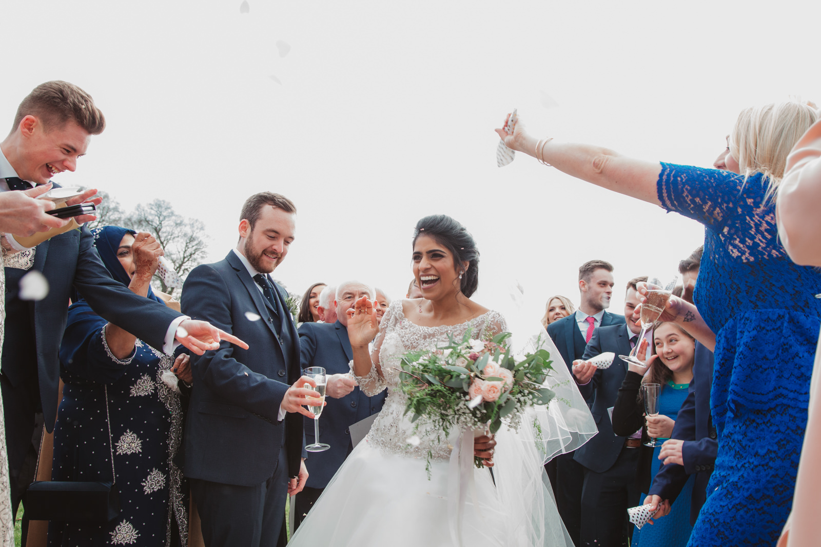 relaxed laughing norfolk couple throwing confetti at southwood hall