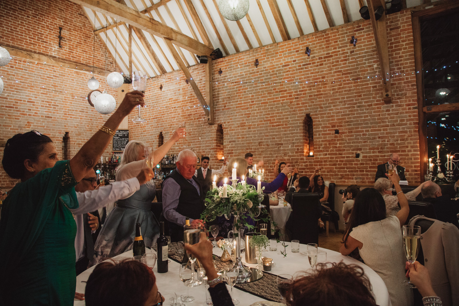 relaxed guests toasting newlyweds at Southwood Hall Norfolk