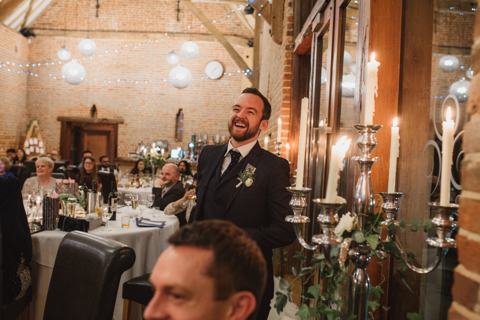 Groom laughing during best man speech at Southwood Hall Norfolk