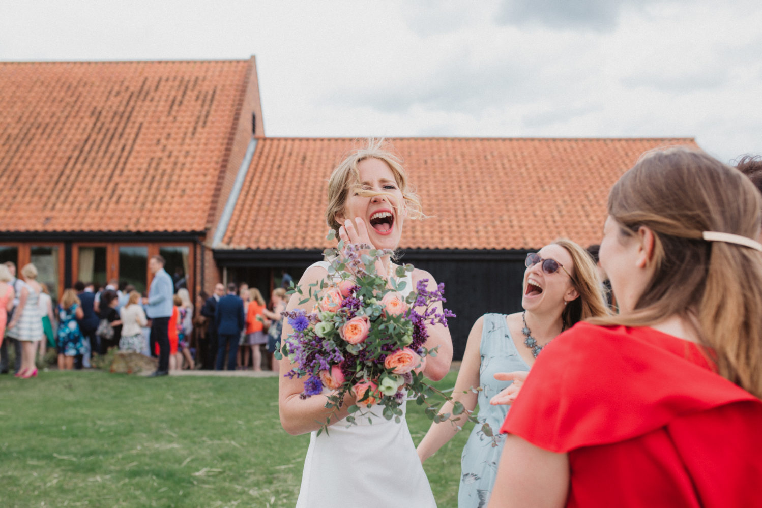 introvert bride laughing at camera at bingham village hall
