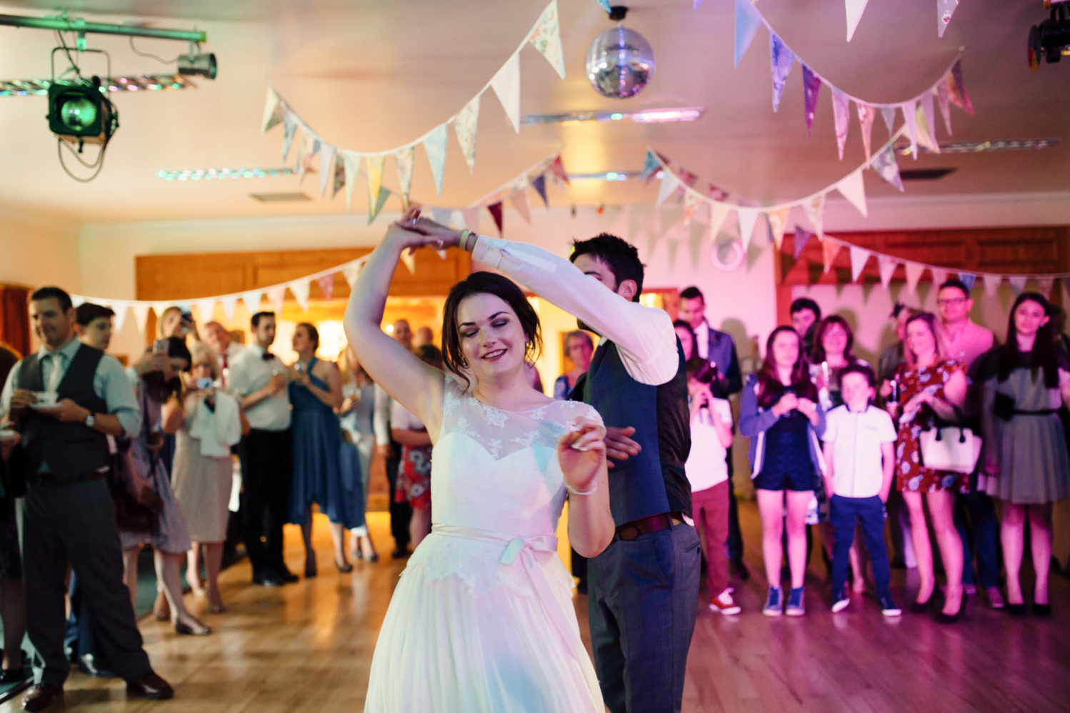bride and groom dancing at saxmundham village hall wedding reception