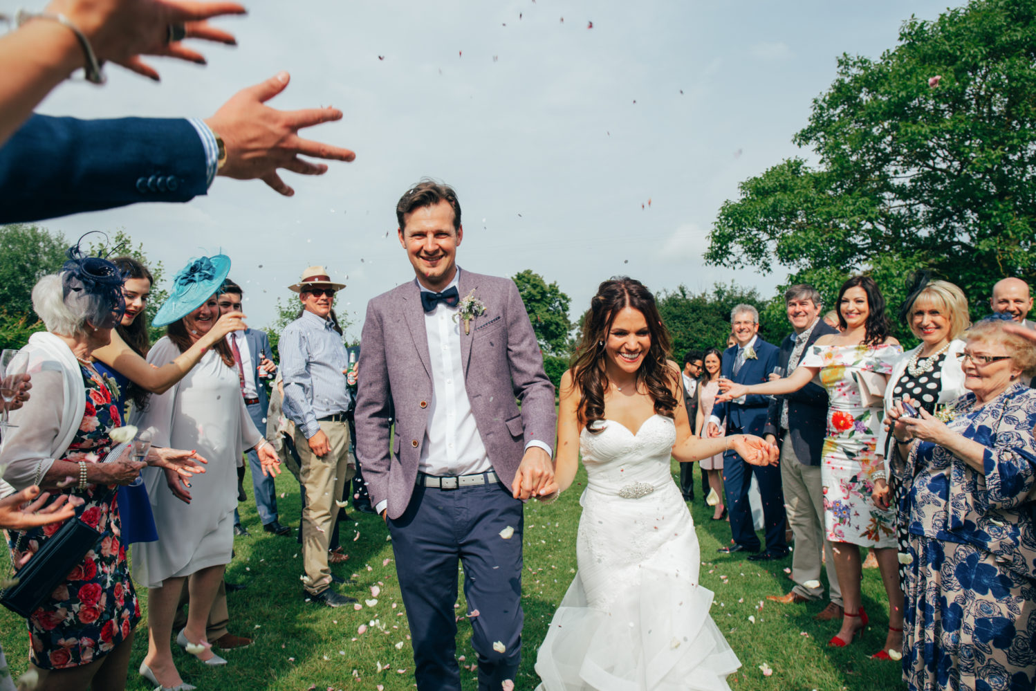 bride and groom laughing during confetti throw at dove barn