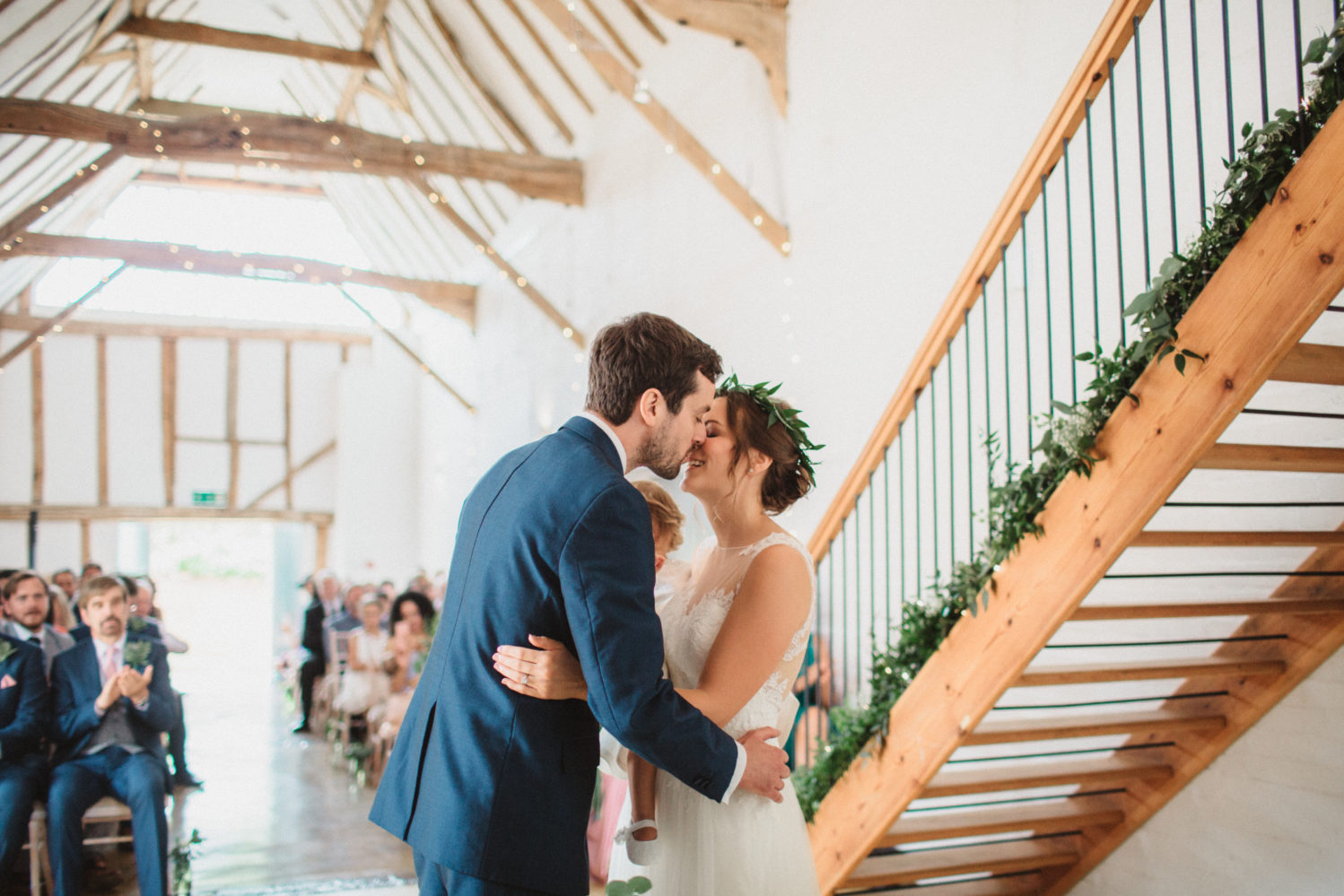 photograph of bride and groom kissing at dove barn wedding