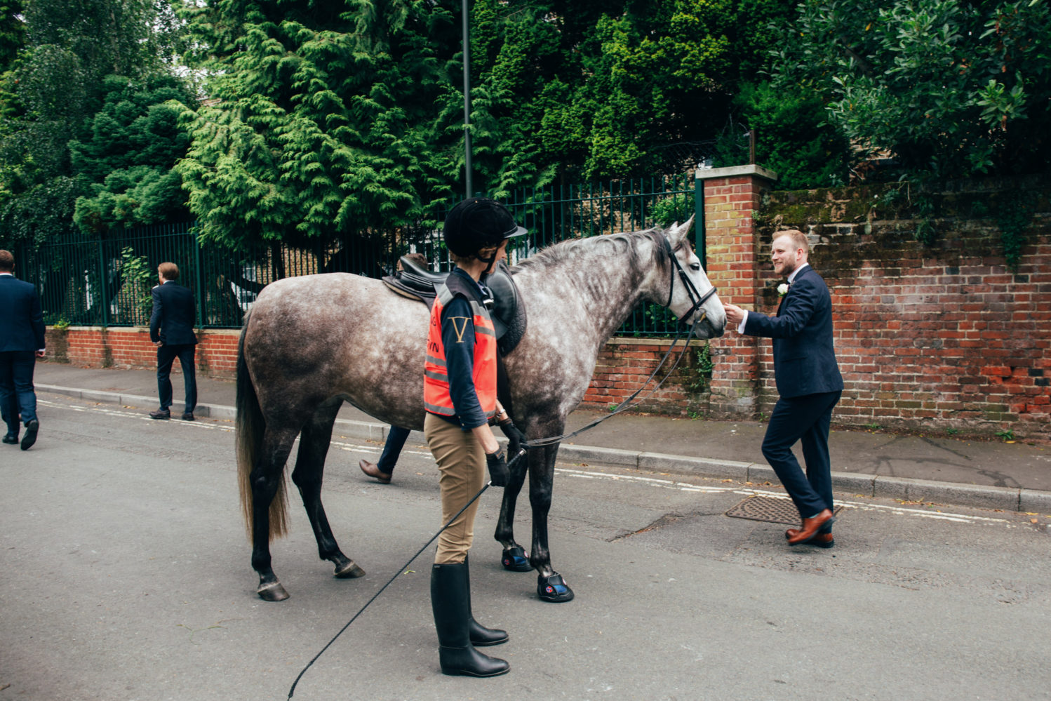 groom stroking horse walking to ceremony