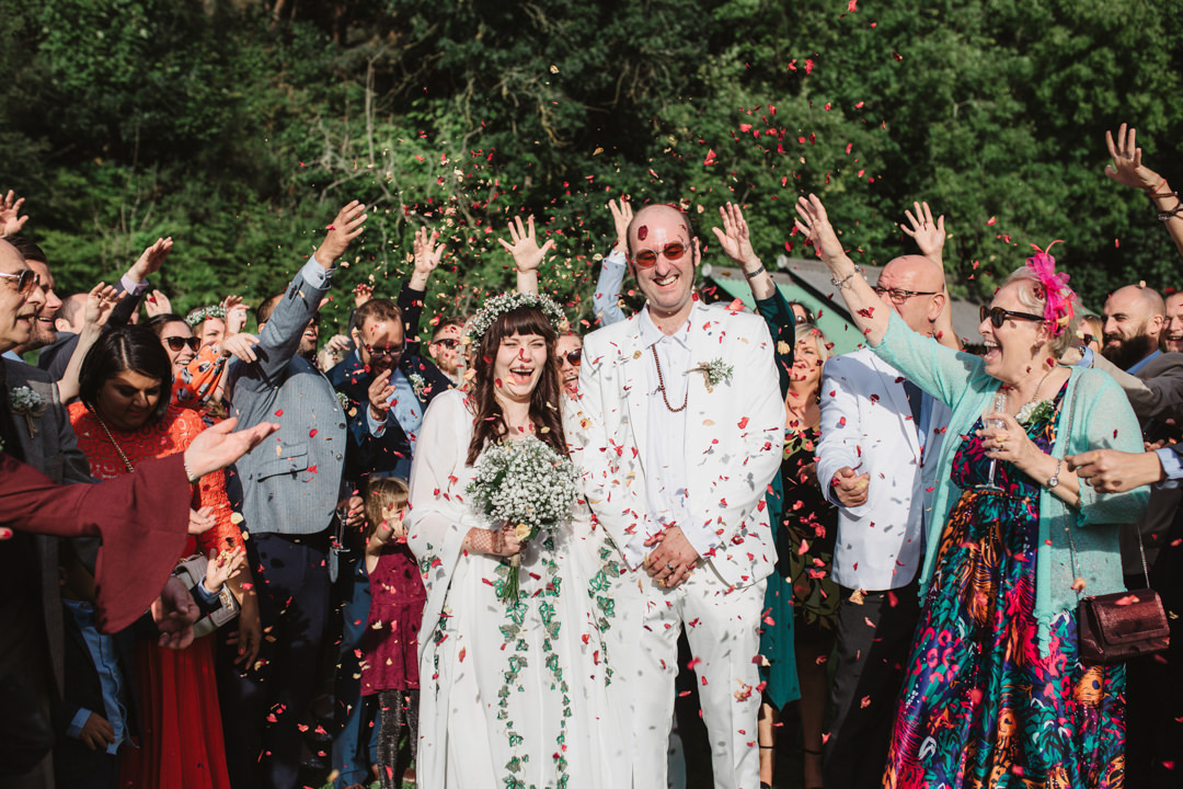 Confetti throw over bride and groom in white at keeper and the dell wedding