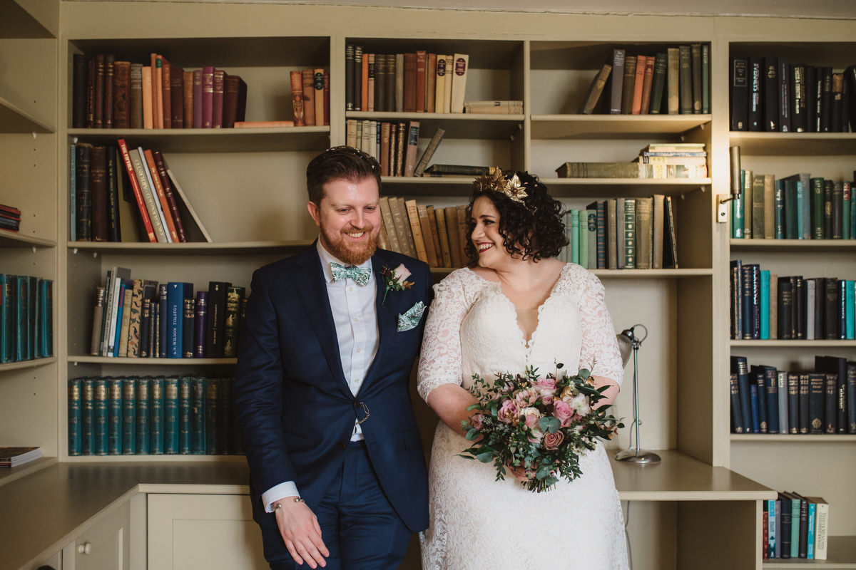 couples portraits in the library at bruisyard hall after the wedding