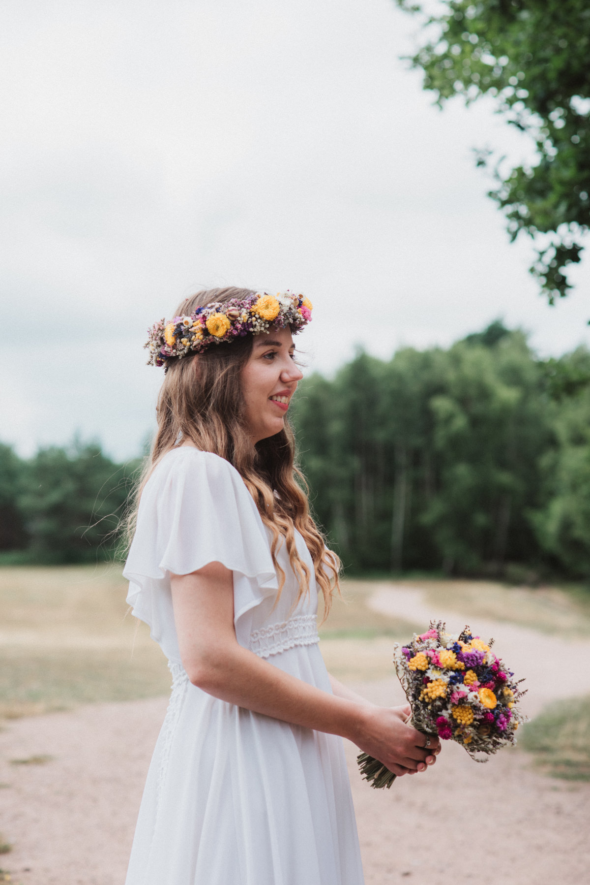 happy bride in flower crown after wedding at Oak Lodge Thetford Forest Wedding Photography 