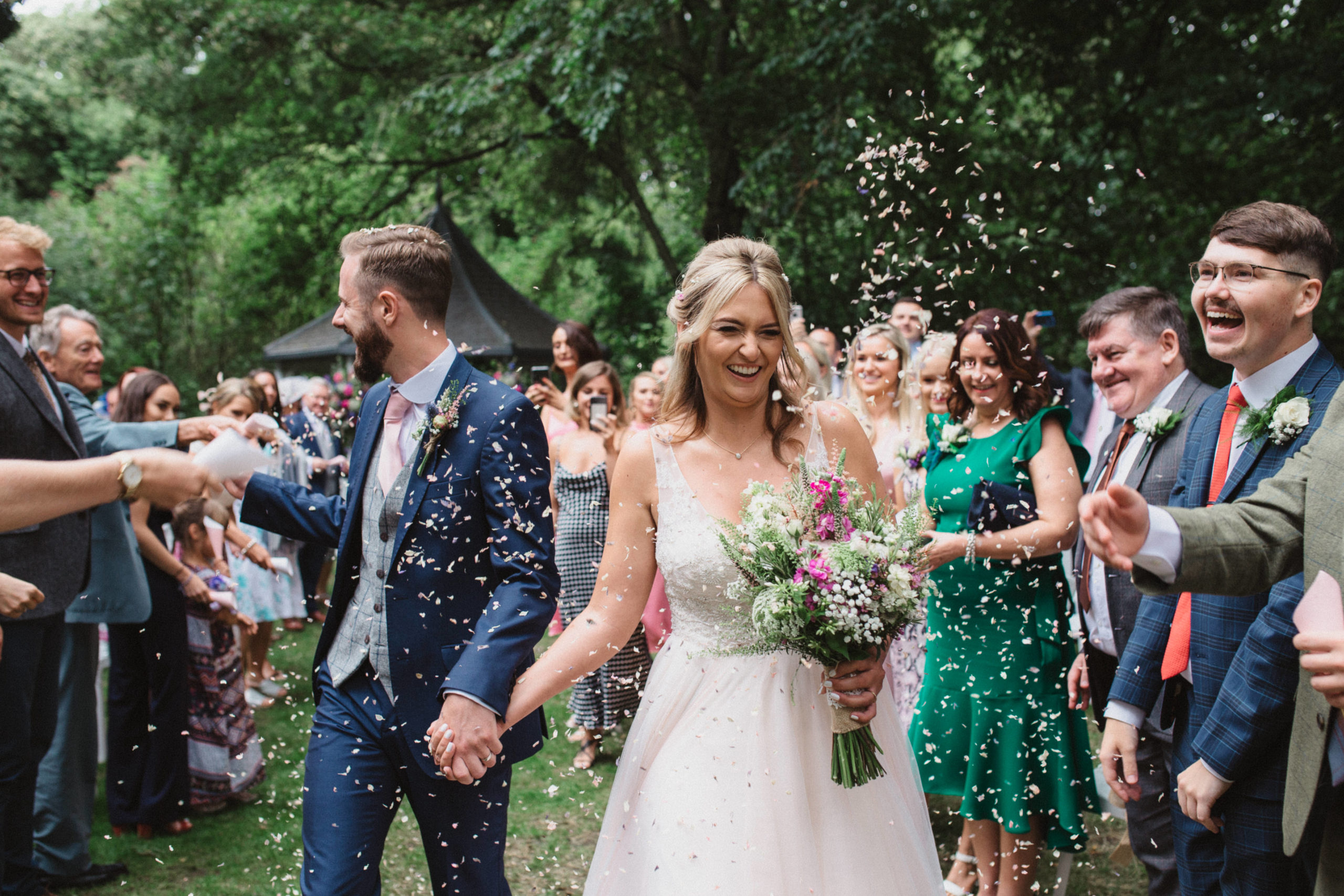 smiling bride during confetti throw at milling barn wedding photography